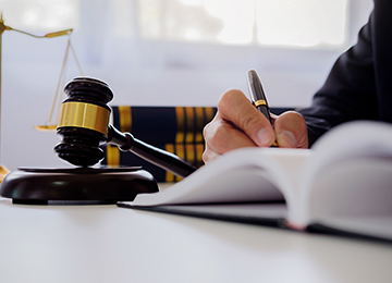 Person writing in book